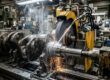 A precision crankshaft grinding machine restoring a worn crankshaft to reduce engine vibration.