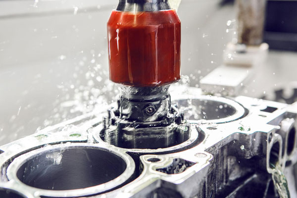 How-Vertical-Cylinder-Honing-Machines-Help-in-Cylinder-Repair-Work Close-up of honing stones creating a precise crosshatch pattern inside an engine block bore during cylinder repair.